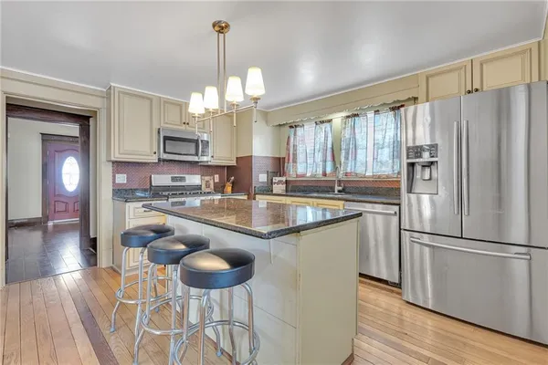 a kitchen with a chandelier furniture and a chandelier