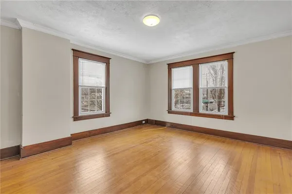 an empty room with wooden floor and closet