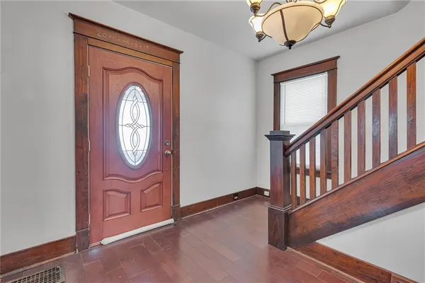 an empty room with fireplace and fan