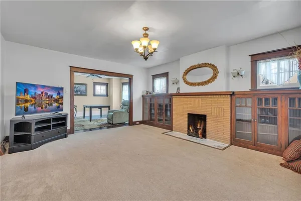 an empty room with windows and chandelier