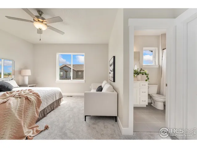 a bedroom with a white bed and white walls