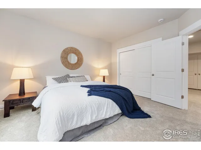 a bedroom with a bed and a lamp