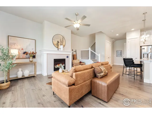 a living room with furniture a fireplace and a large mirror