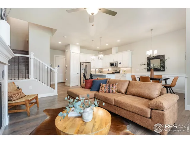 a living room with furniture kitchen view and a dining table