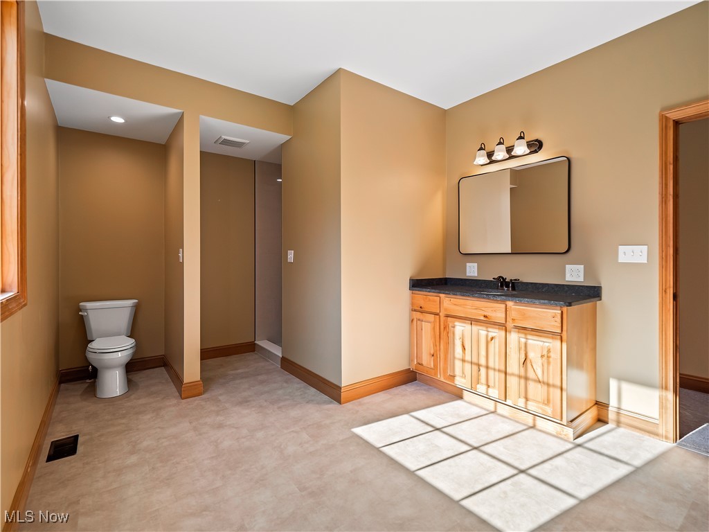 12740 Root Road Columbia Station, OH 44028 - Photo 33 of 47 Bathroom with vanity, toilet, baseboards, and visible vents
