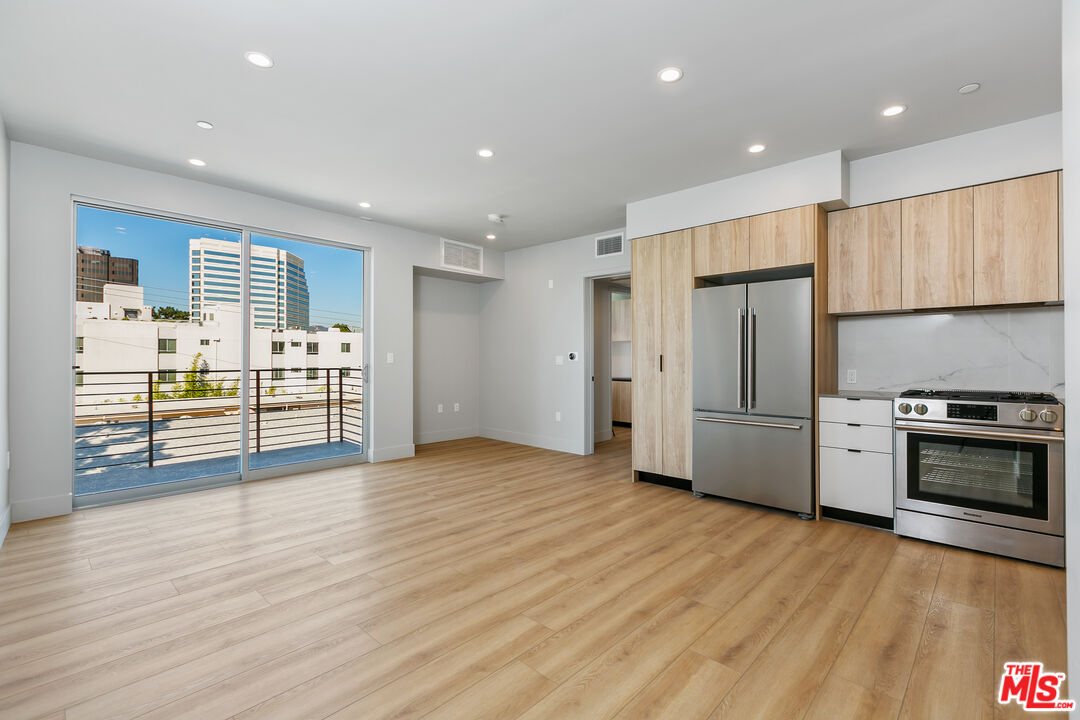 12431 Rochester Avenue, Unit PH7 Los Angeles, CA 90025 - Photo 1 of 23 a view of kitchen with stainless steel appliances kitchen island wooden floors and stove