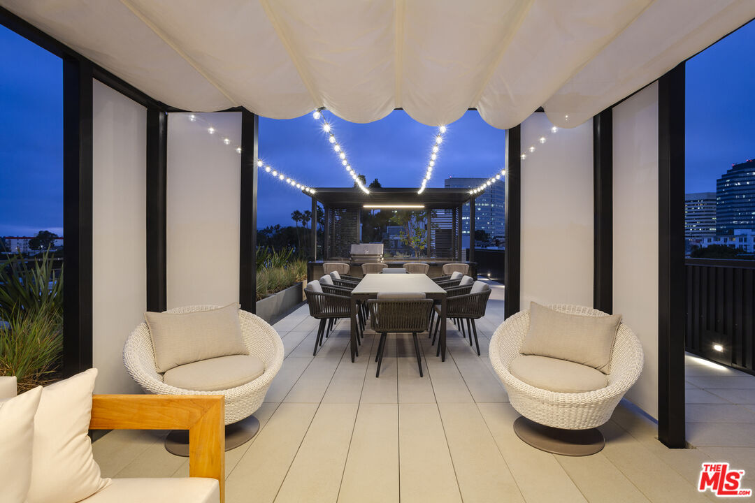 12431 Rochester Avenue, Unit PH7 Los Angeles, CA 90025 - Photo 19 of 23 a living room with furniture and a wooden floor