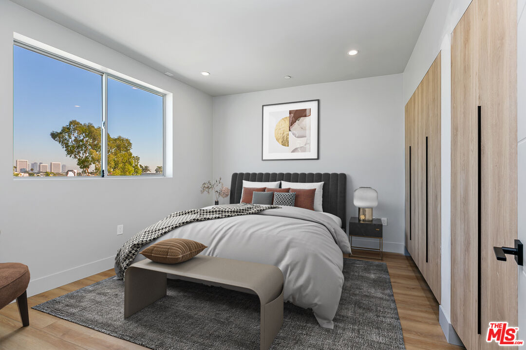 12431 Rochester Avenue, Unit PH7 Los Angeles, CA 90025 - Photo 9 of 23 a bedroom with a bed and a painting on the wall