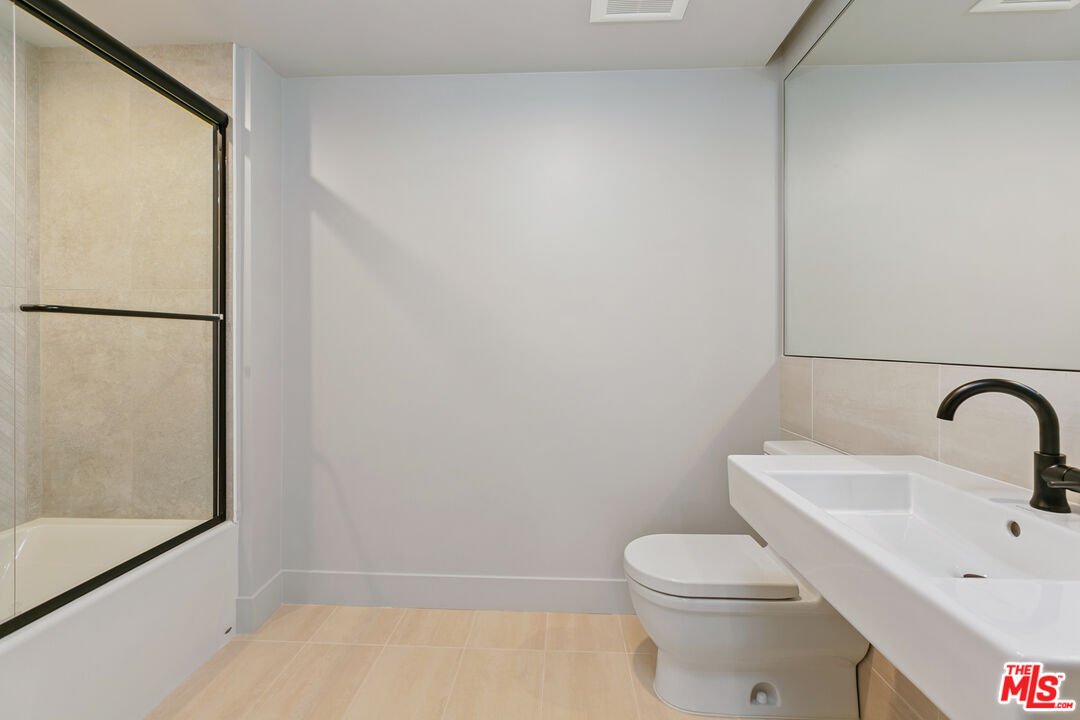 12431 Rochester Avenue, Unit PH7 Los Angeles, CA 90025 - Photo 10 of 23 a bathroom with a sink toilet and shower