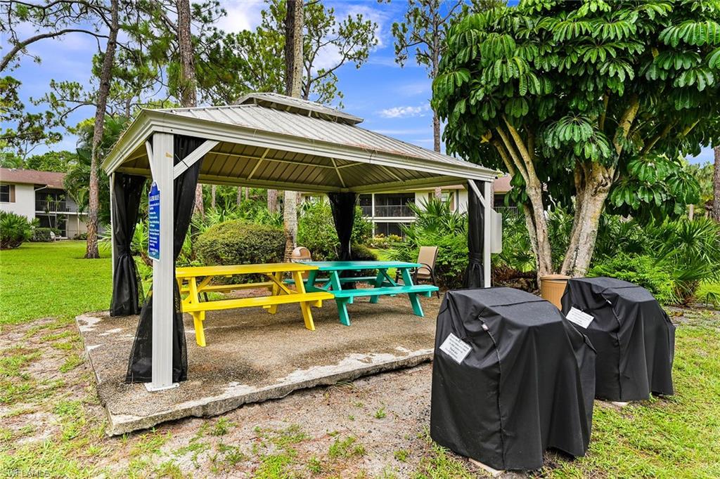 1933 Courtyard Way, Unit D103 Naples, FL 34112 - Photo 23 of 24 a view of outdoor space yard deck patio and swimming pool