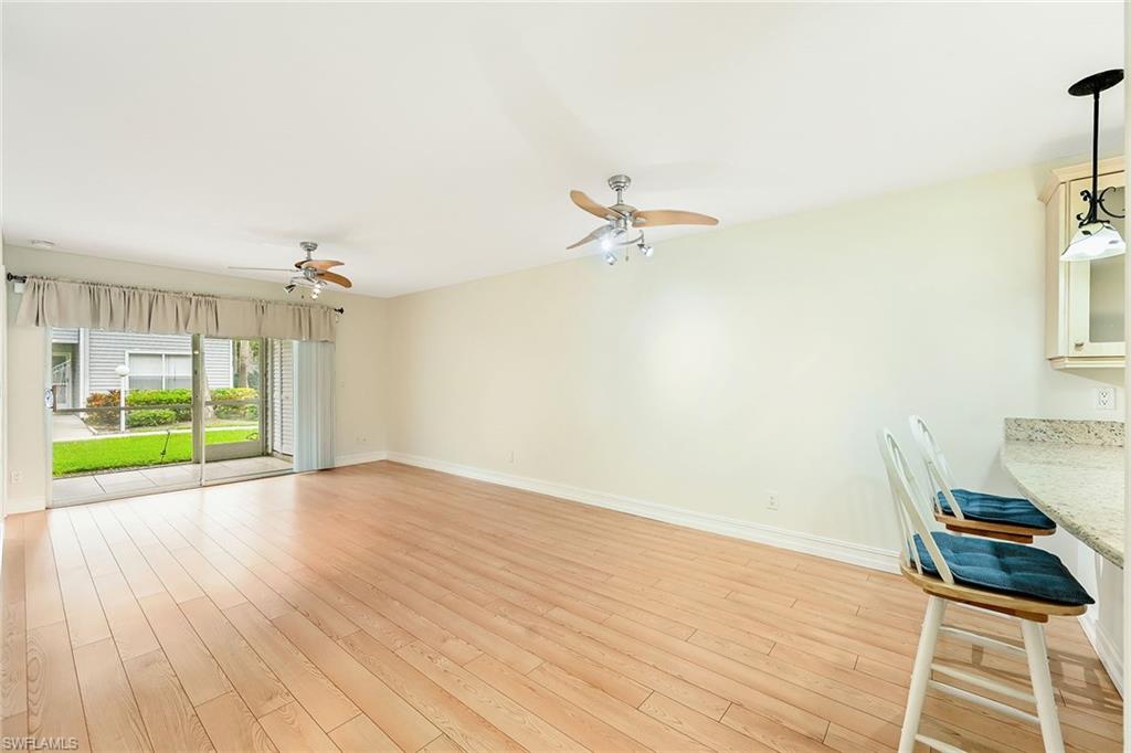 1933 Courtyard Way, Unit D103 Naples, FL 34112 - Photo 3 of 24 wooden floor in an empty room with a window