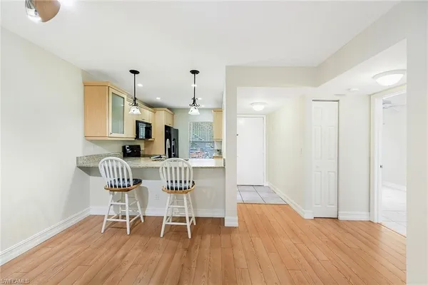 a dining room with furniture and wooden floor