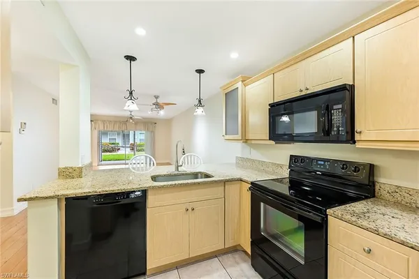 a kitchen with a sink stove and microwave