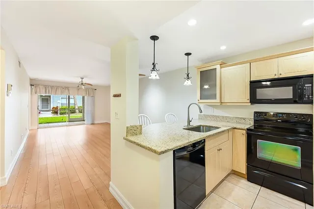 a kitchen with a sink and a stove top oven