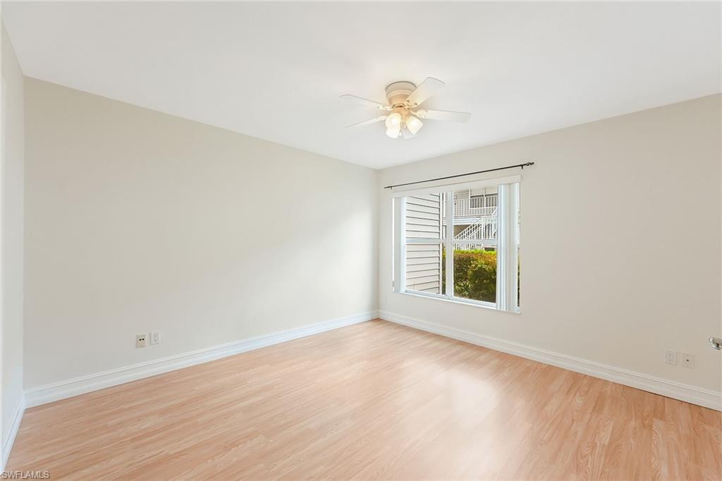 1933 Courtyard Way, Unit D103 Naples, FL 34112 - Photo 10 of 24 a view of an empty room with a window