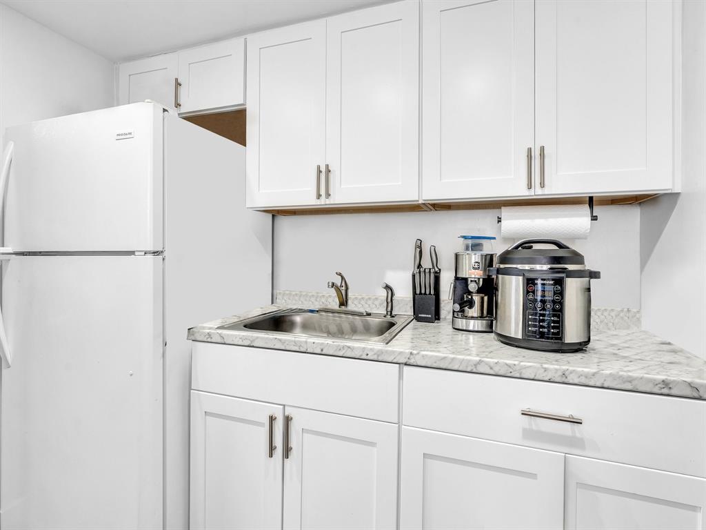 1052 Northwest 103rd Street Miami, FL 33150 - Photo 11 of 40 a kitchen with granite countertop white cabinets and white appliances