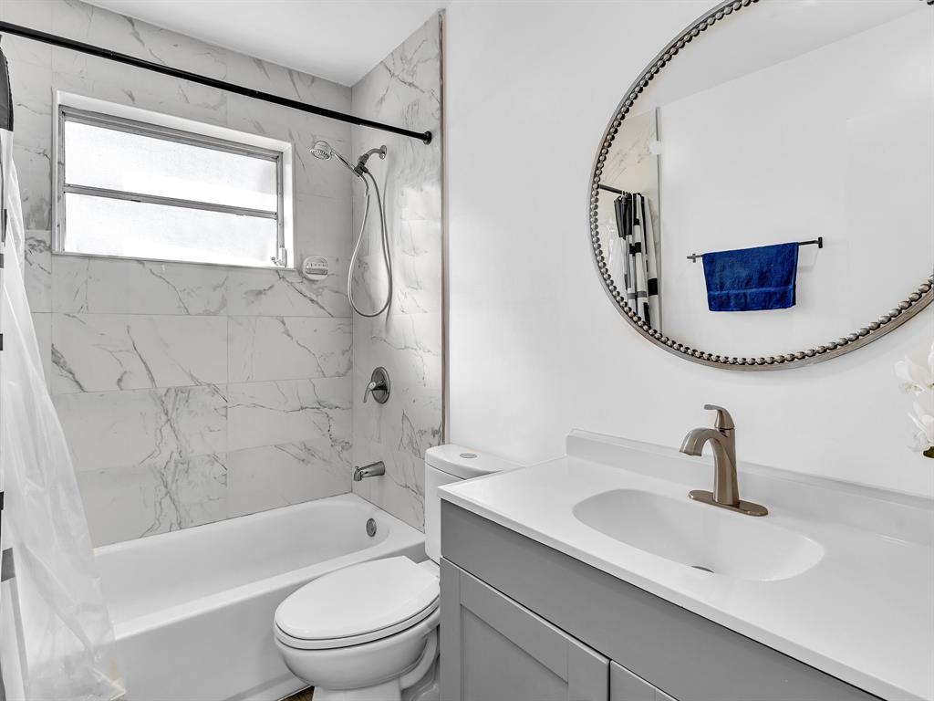 1052 Northwest 103rd Street Miami, FL 33150 - Photo 13 of 40 a bathroom with a sink a toilet and a mirror