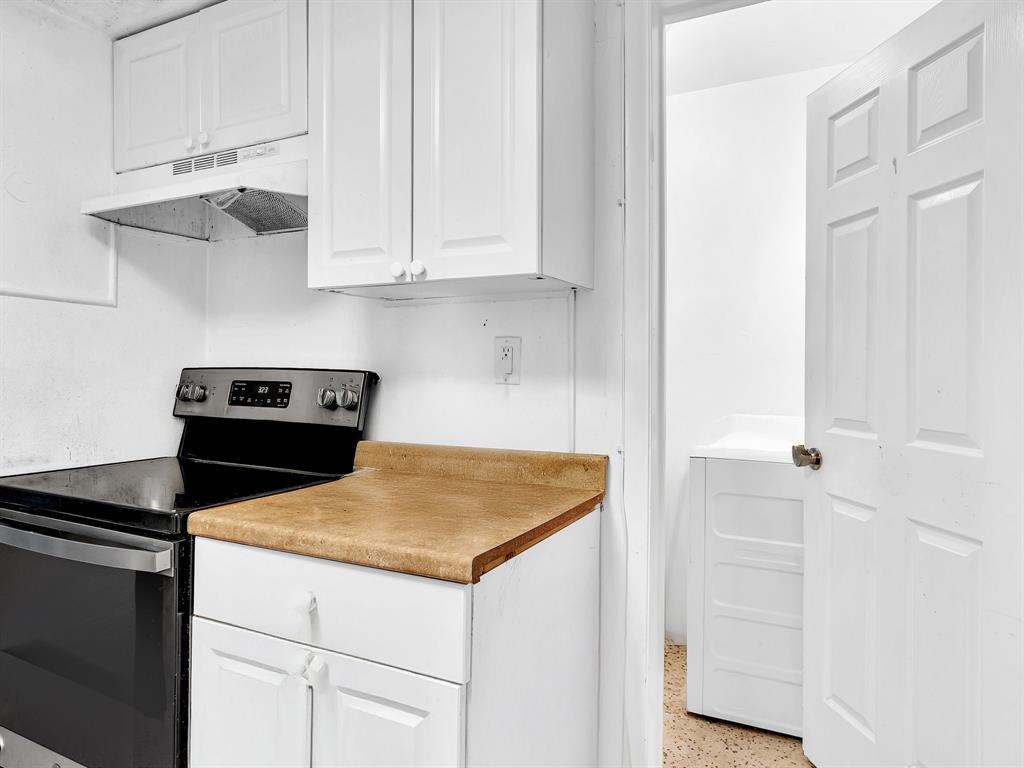 1052 Northwest 103rd Street Miami, FL 33150 - Photo 28 of 40 a kitchen with white cabinets and sink