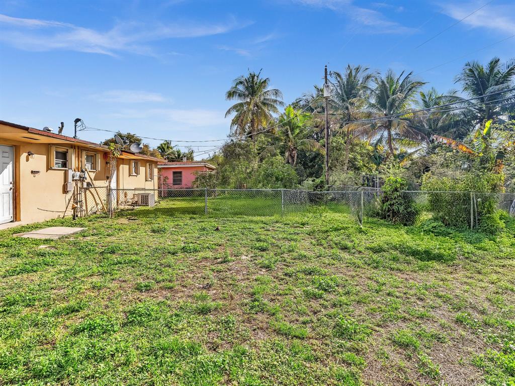 1052 Northwest 103rd Street Miami, FL 33150 - Photo 37 of 40 a backyard of a house with lots of green space and garden view