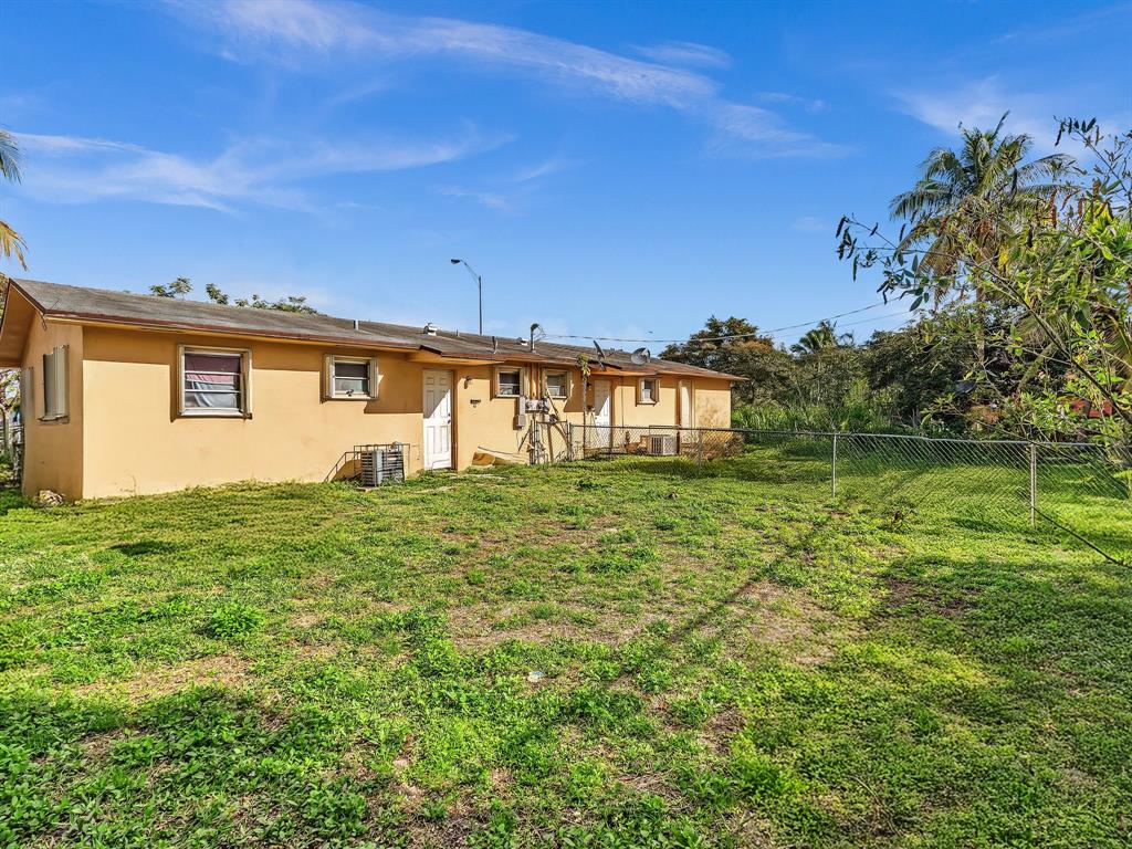 1052 Northwest 103rd Street Miami, FL 33150 - Photo 38 of 40 a front view of a house with a yard