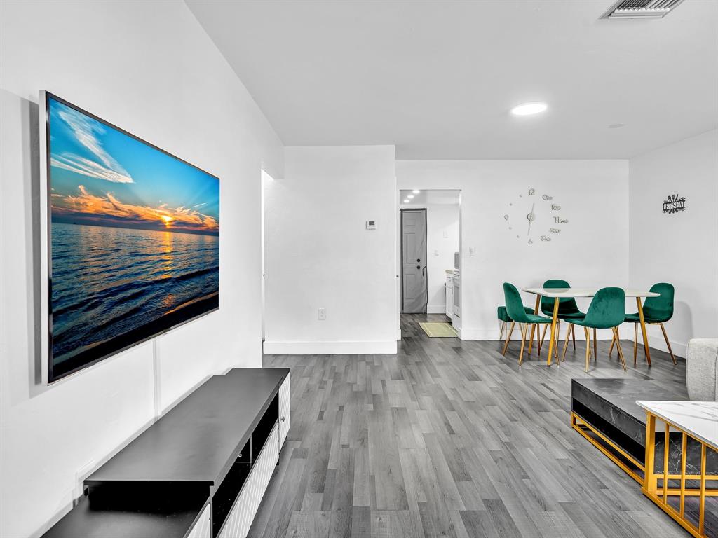 1052 Northwest 103rd Street Miami, FL 33150 - Photo 5 of 40 a living room with furniture and a flat screen tv