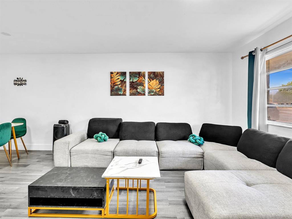 1052 Northwest 103rd Street Miami, FL 33150 - Photo 6 of 40 a living room with furniture and a lamp