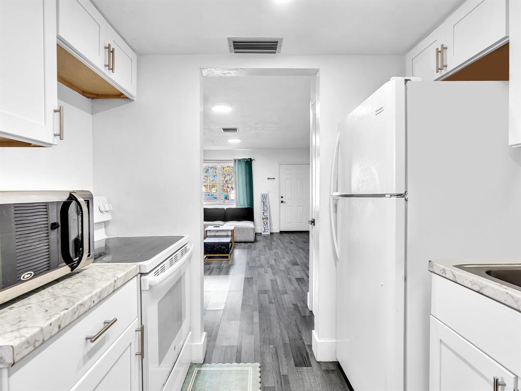 1052 Northwest 103rd Street Miami, FL 33150 - Photo 10 of 40 a kitchen with a refrigerator and a sink