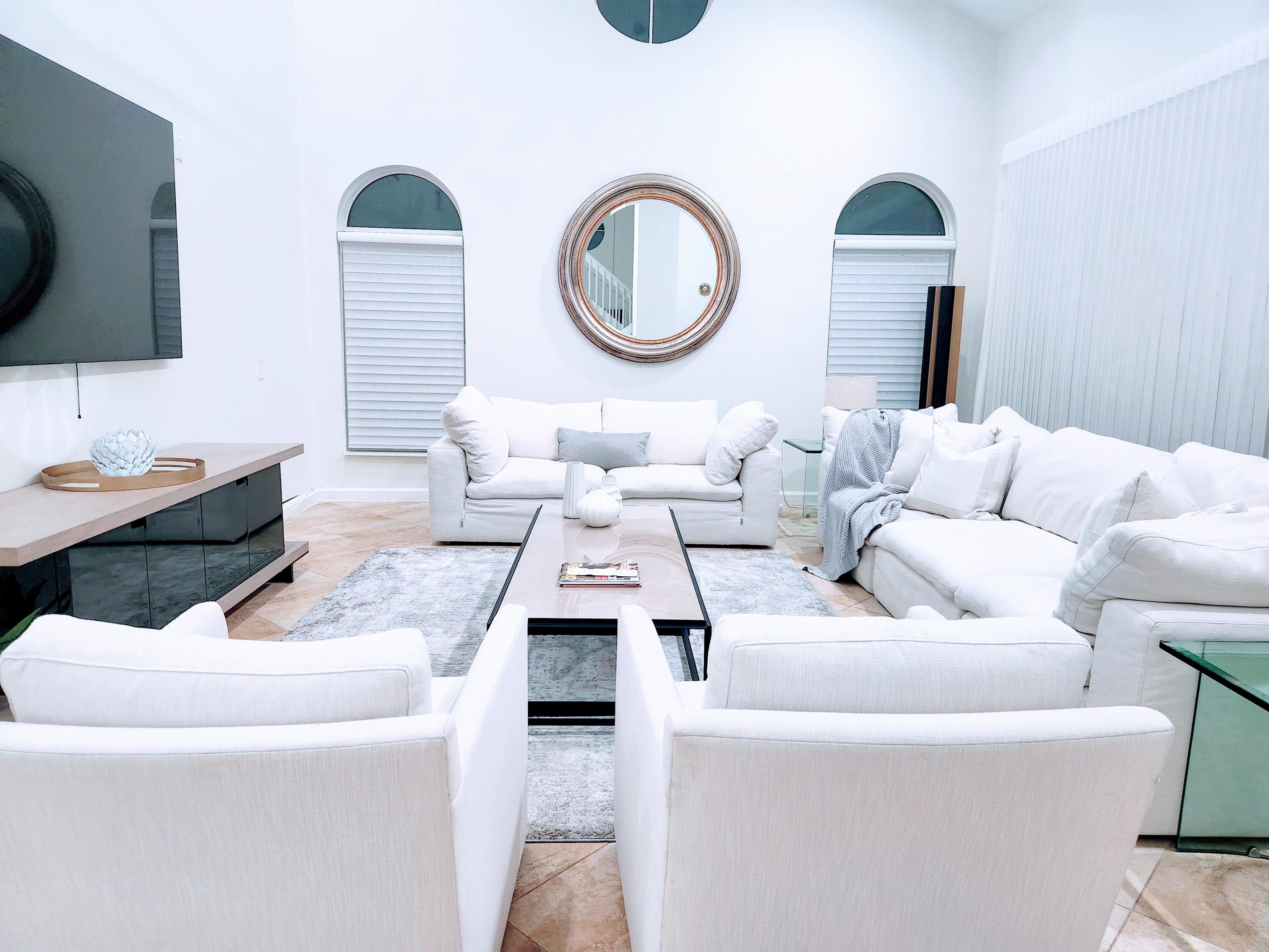 3567 Commodore Circle Delray Beach, FL 33483 - Photo 8 of 76 a living room with furniture and a flat screen tv