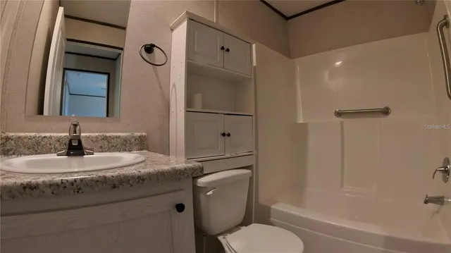 a view of a room with wooden floor and windows