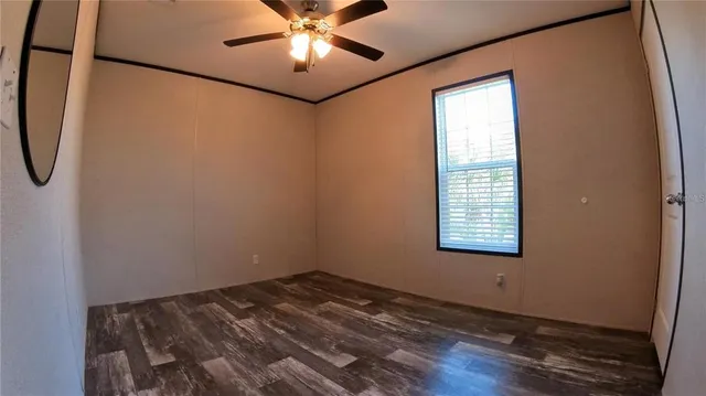 a view of a room with wooden floor
