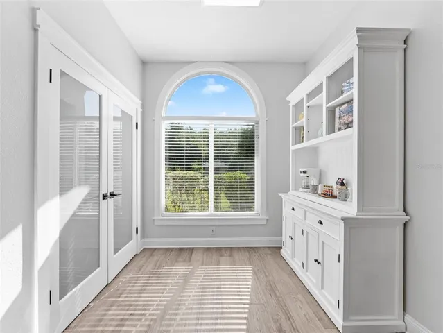 a view of an entryway with wooden floor and windows