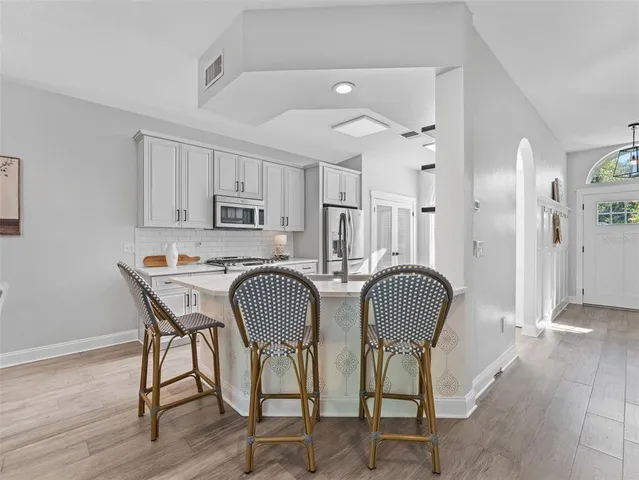 a view of a dining room with furniture a chandelier and wooden floor