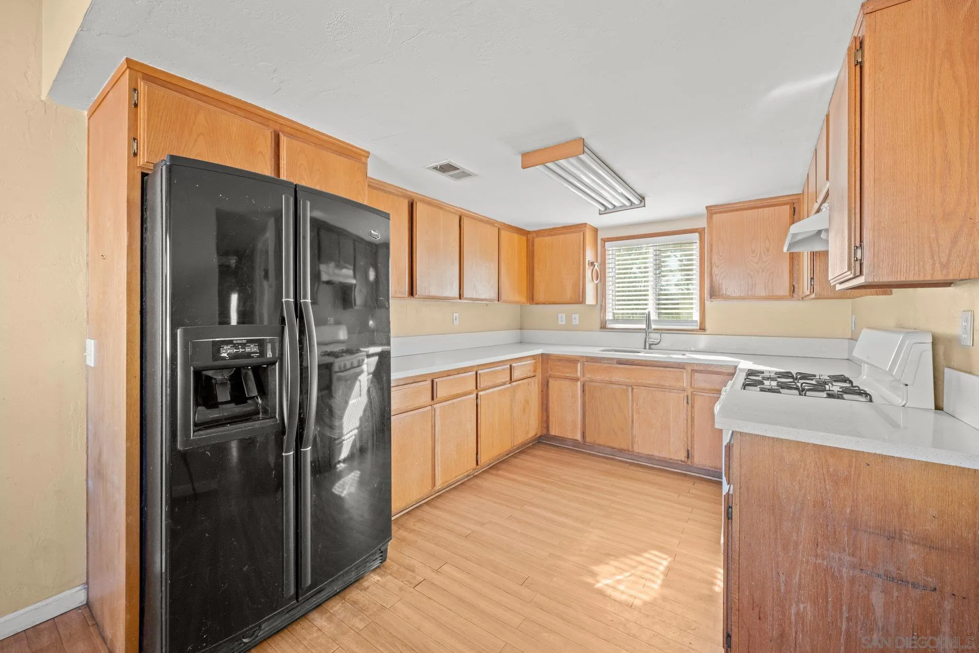1703 Ashley Road Ramona, CA 92065 - Photo 24 of 36 a large kitchen with a refrigerator a sink a stove and cabinets