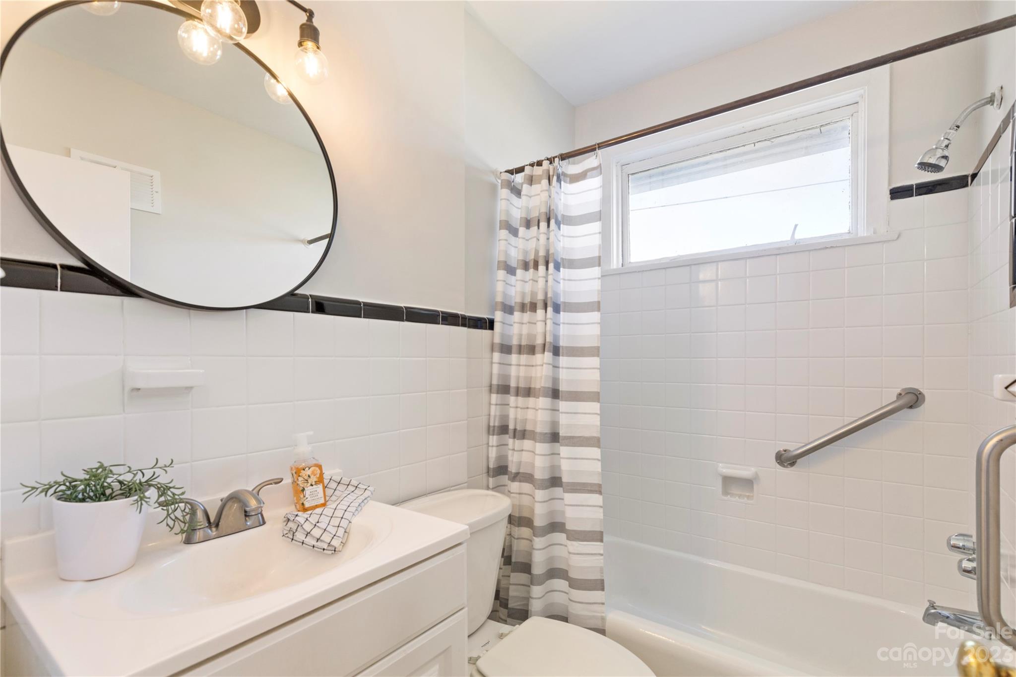 350 South Sharon Amity Road Charlotte, NC 28211 - Photo 14 of 21 a bathroom with a sink mirror and toilet