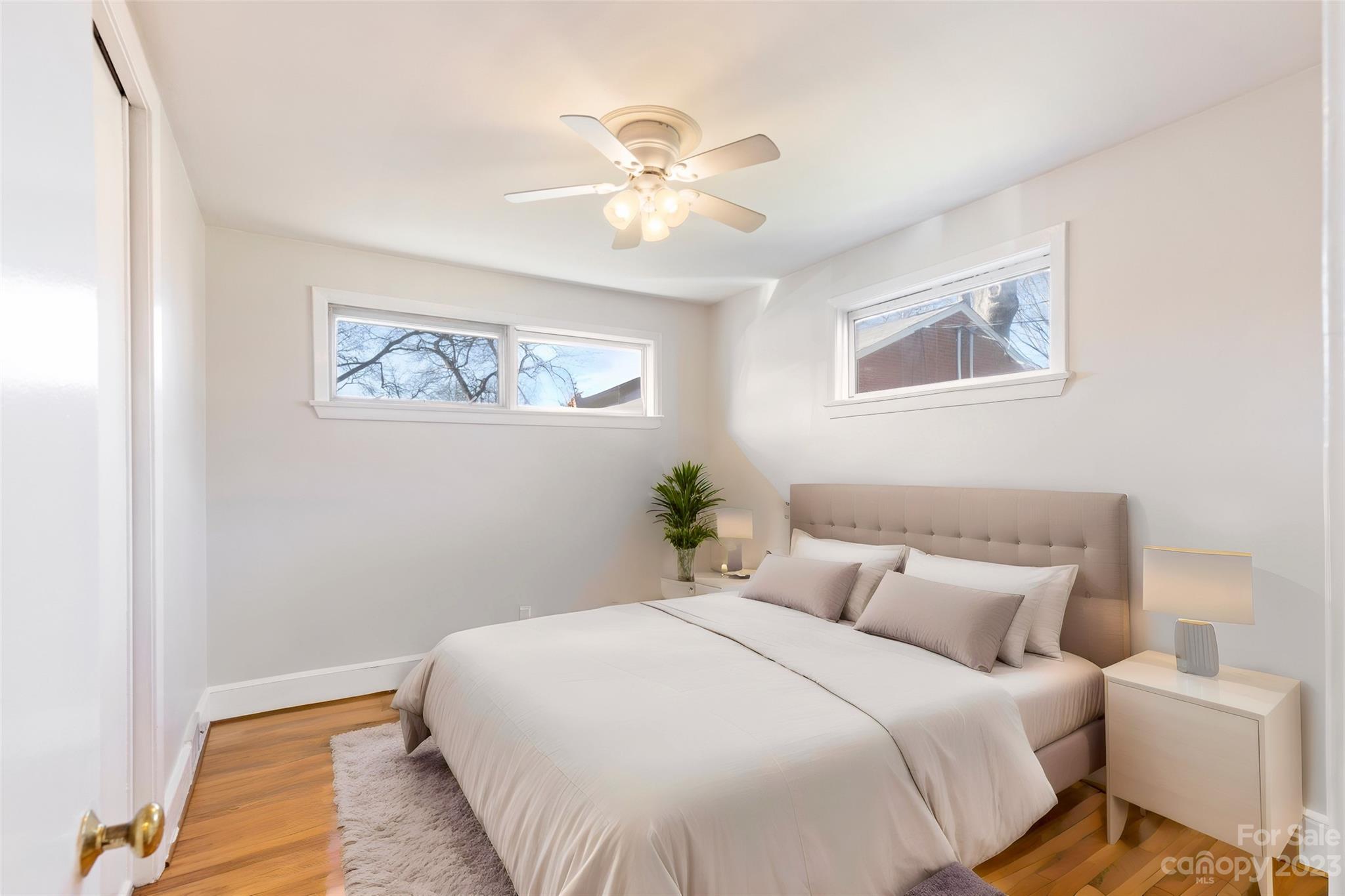 350 South Sharon Amity Road Charlotte, NC 28211 - Photo 15 of 21 a bedroom with a bed and a chandelier