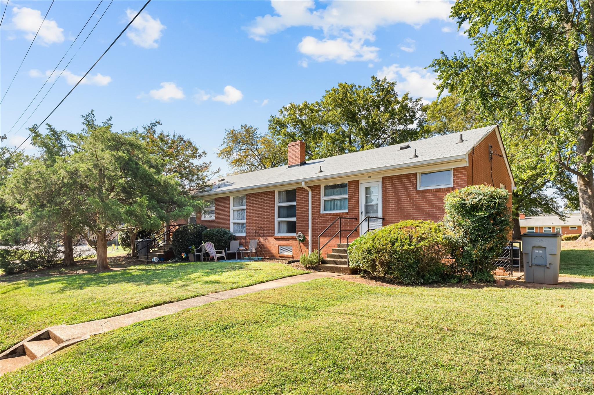350 South Sharon Amity Road Charlotte, NC 28211 - Photo 21 of 21 a view of a yard in front of a house with plants and large tree