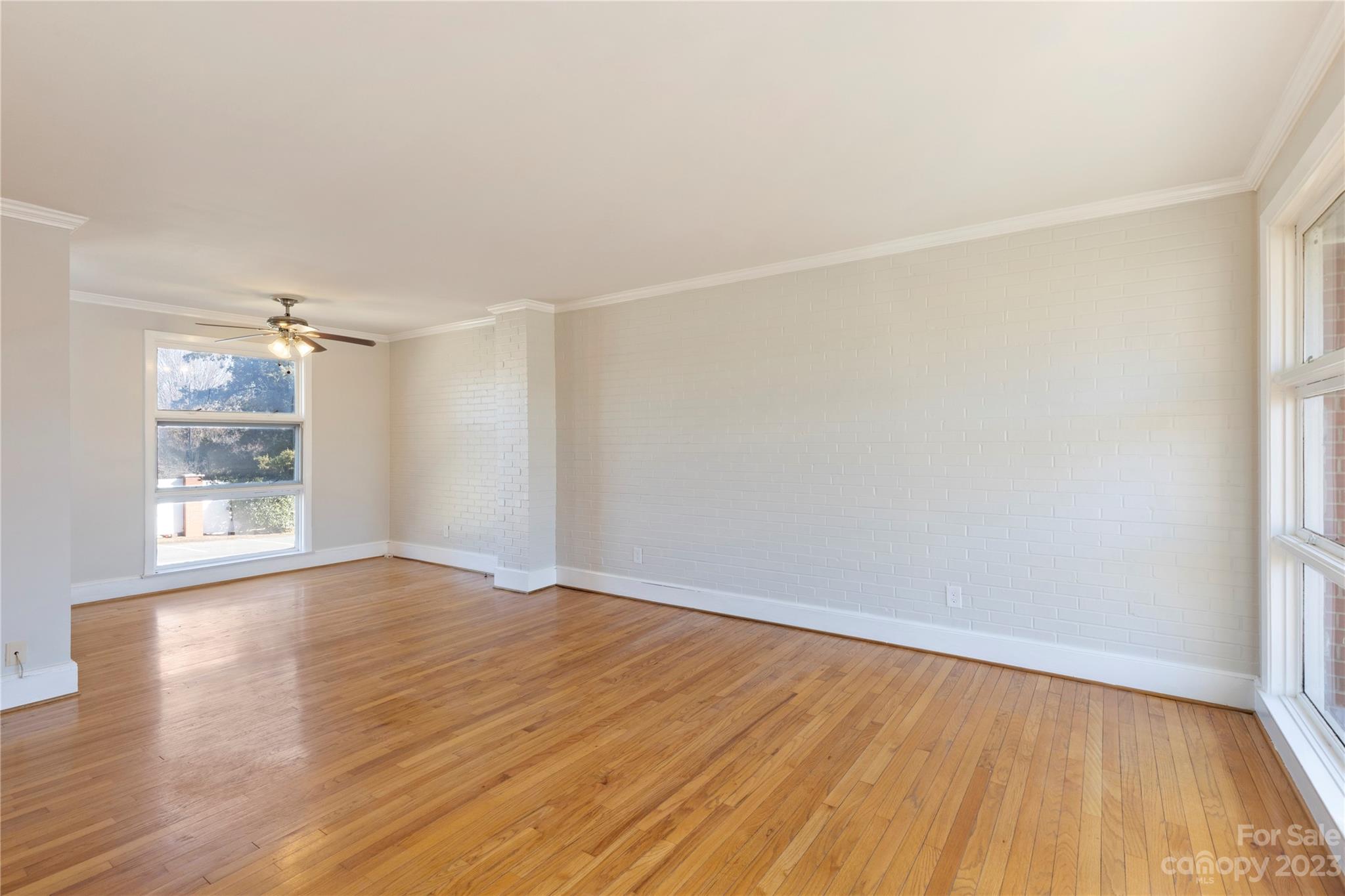 350 South Sharon Amity Road Charlotte, NC 28211 - Photo 3 of 21 an empty room with wooden floor and windows