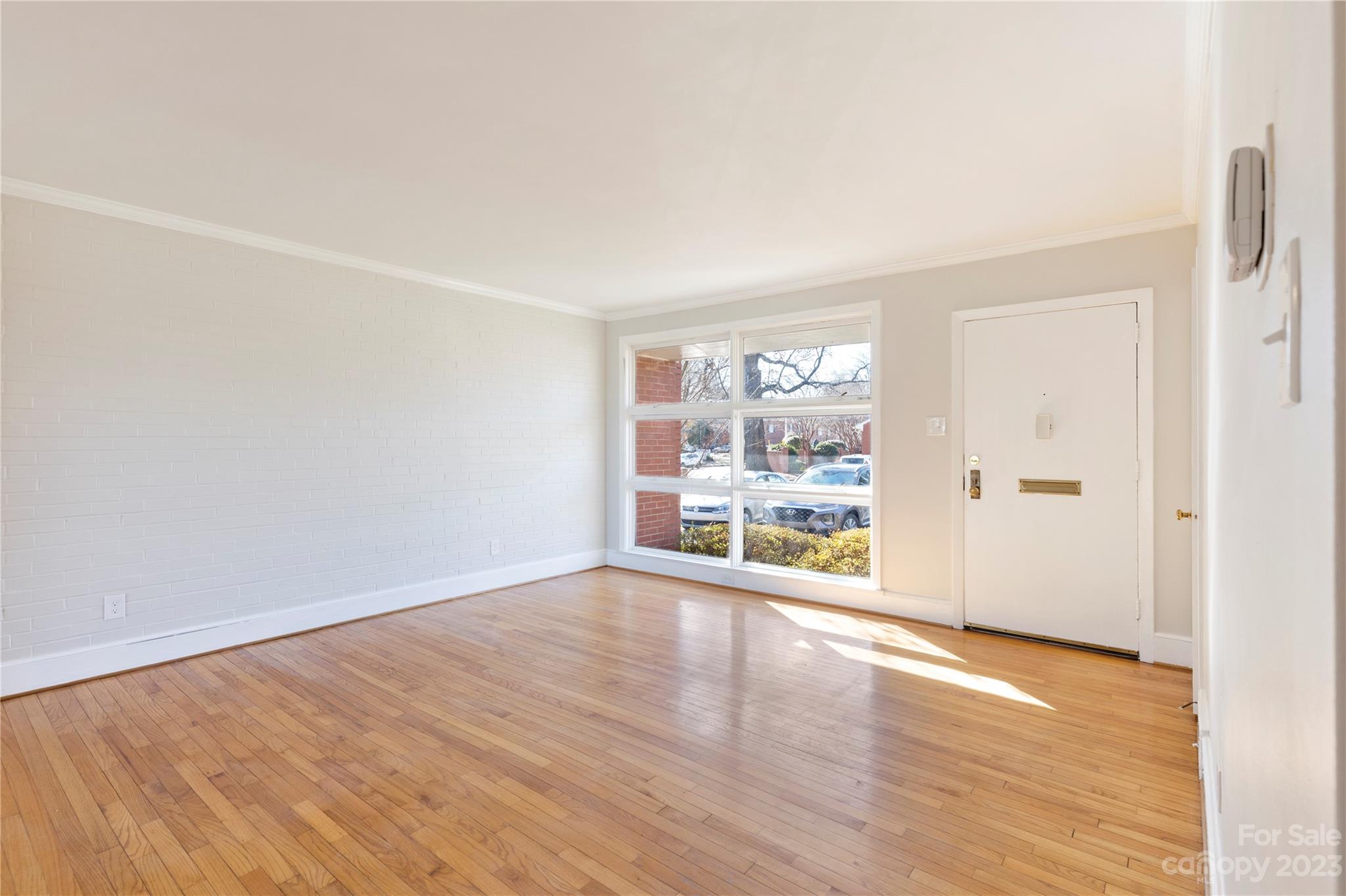 350 South Sharon Amity Road Charlotte, NC 28211 - Photo 5 of 21 an empty room with wooden floor and windows