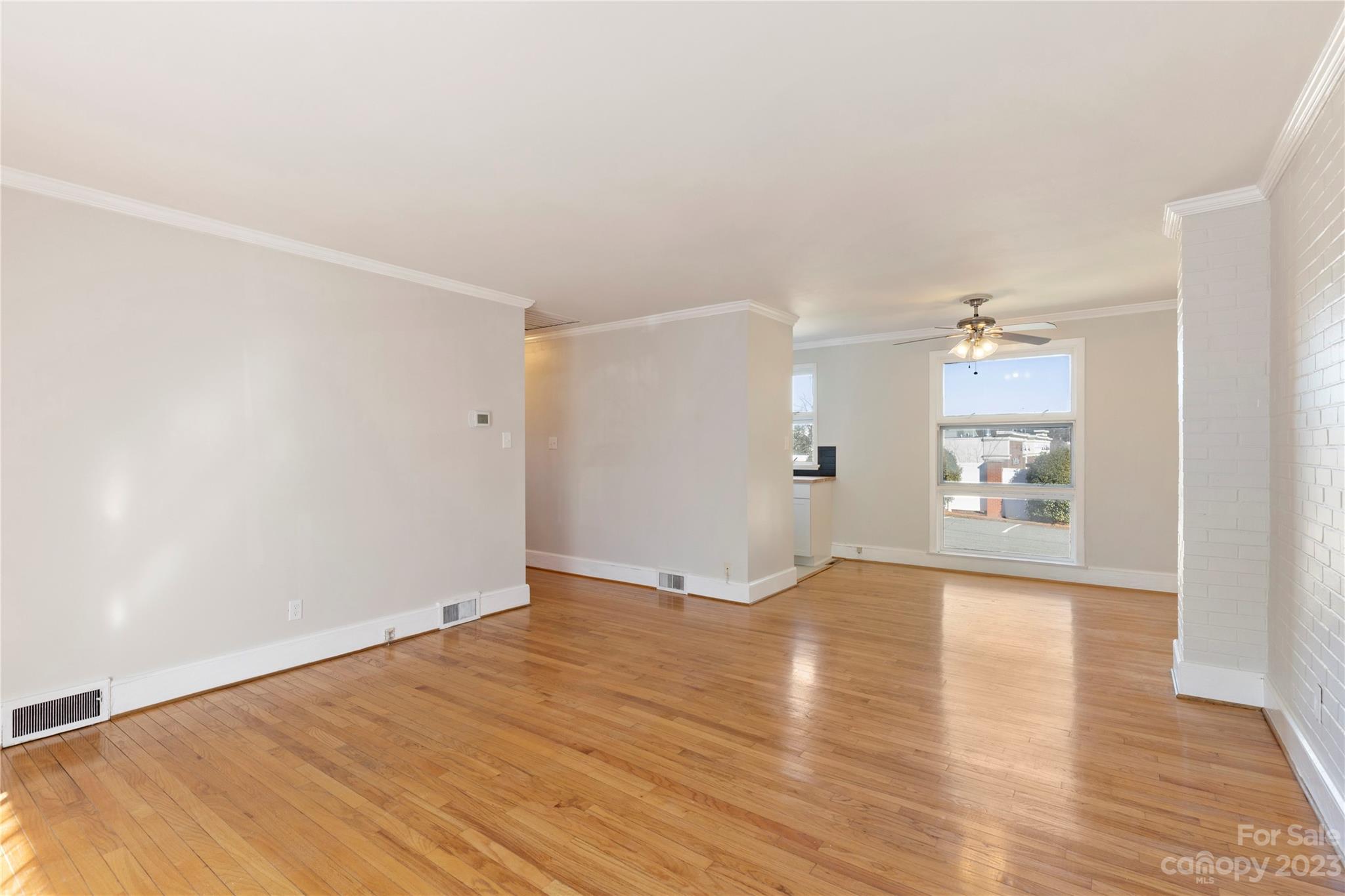 350 South Sharon Amity Road Charlotte, NC 28211 - Photo 7 of 21 an empty room with wooden floor and windows
