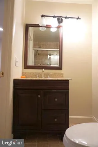 a bathroom with a sink a toilet and mirror