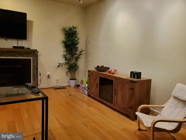 a livingroom with a flat screen tv and a fireplace