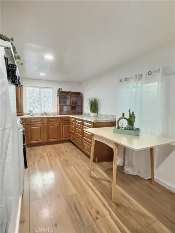 a large white kitchen with sink and cabinets