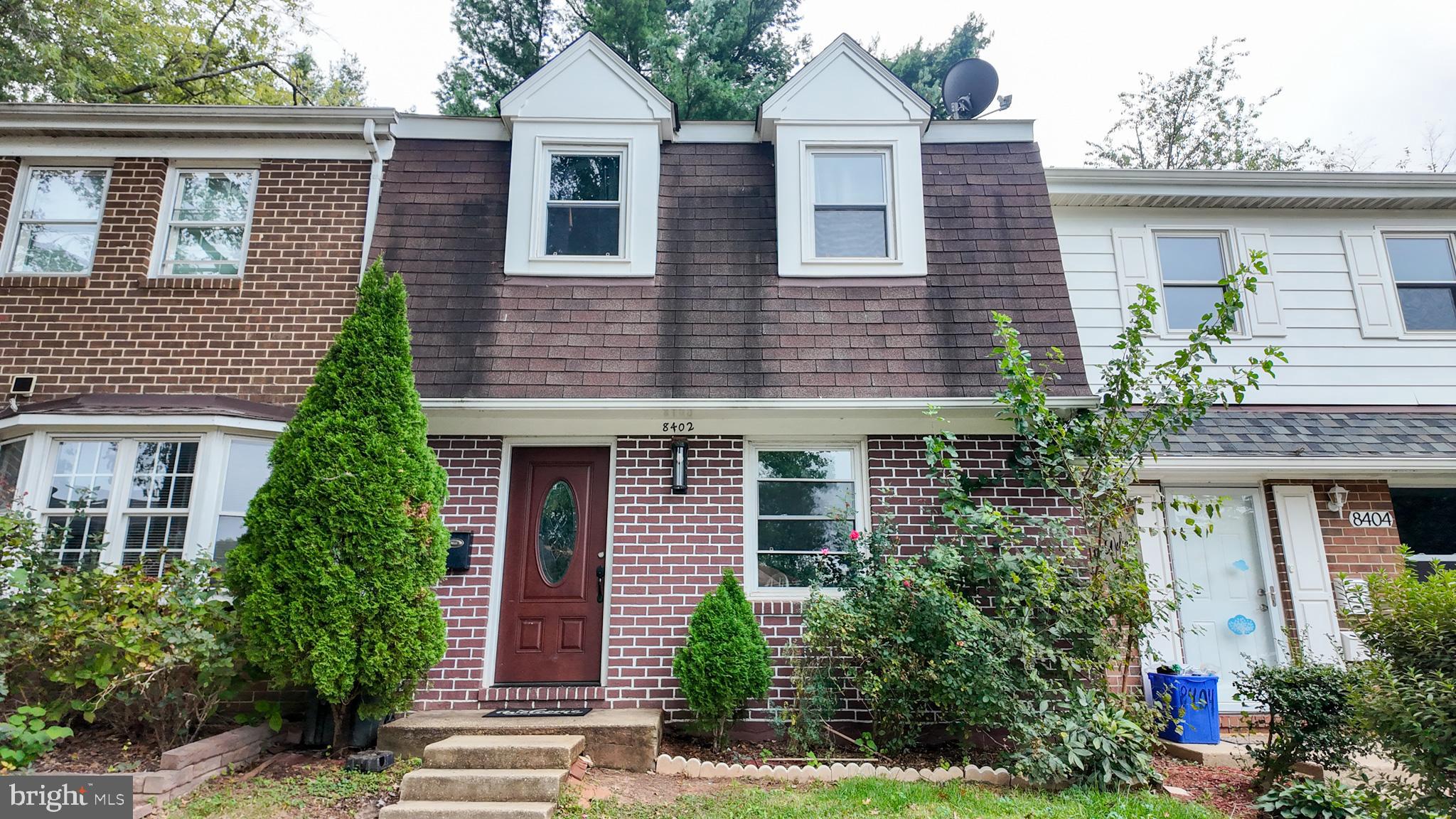 8402 Towne Crest Court Gaithersburg, MD 20877 - Photo 1 of 22 Charming brick townhouse with lush greenery.