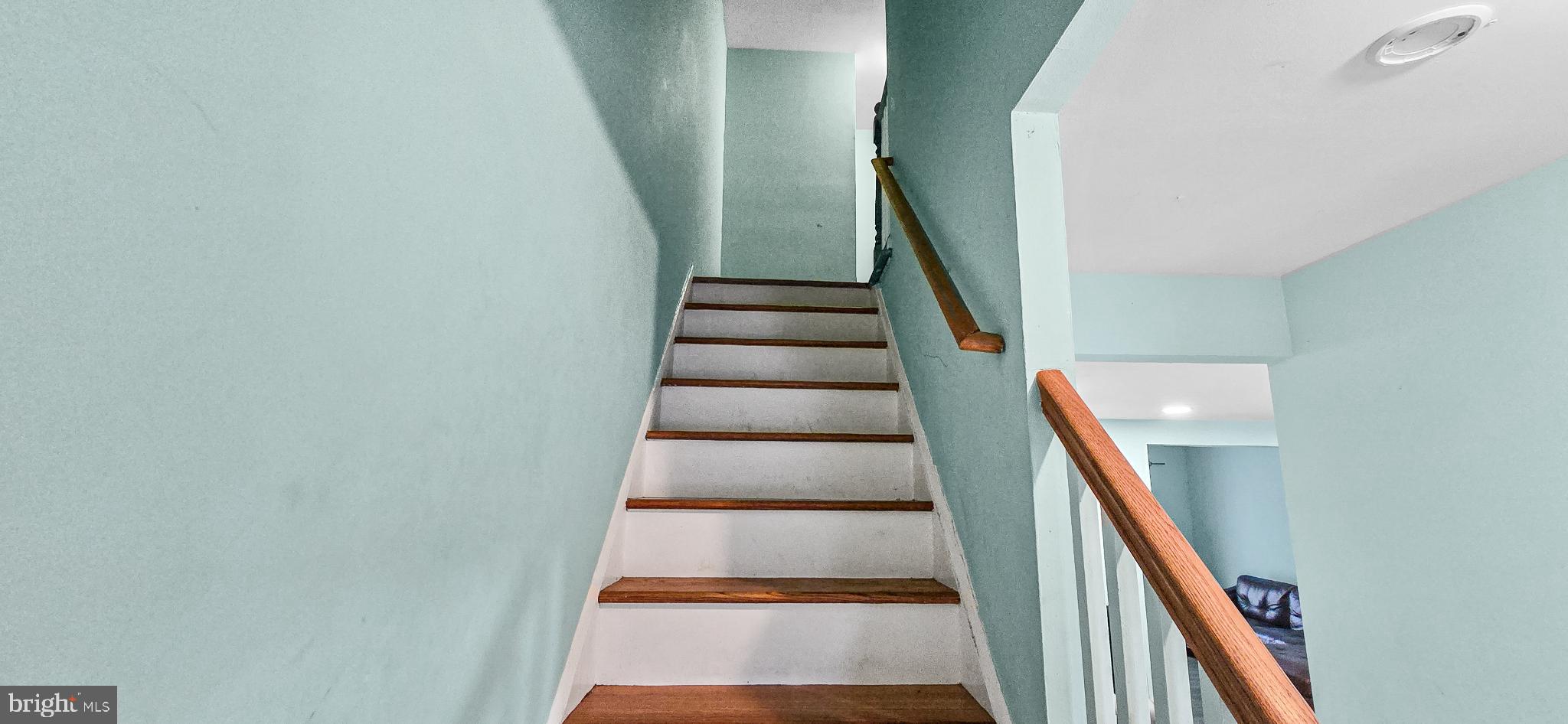 8402 Towne Crest Court Gaithersburg, MD 20877 - Photo 14 of 22 Inviting staircase with serene blue walls.