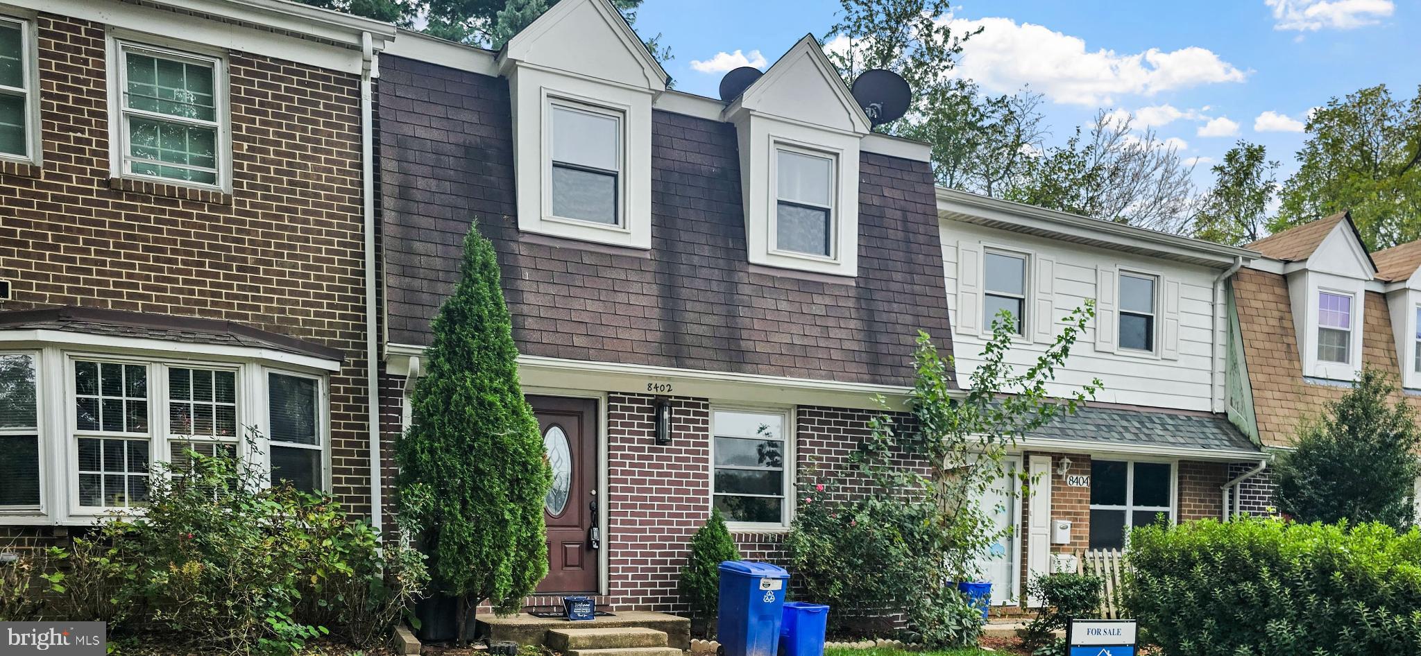 8402 Towne Crest Court Gaithersburg, MD 20877 - Photo 2 of 22 Charming townhouse with lush greenery.