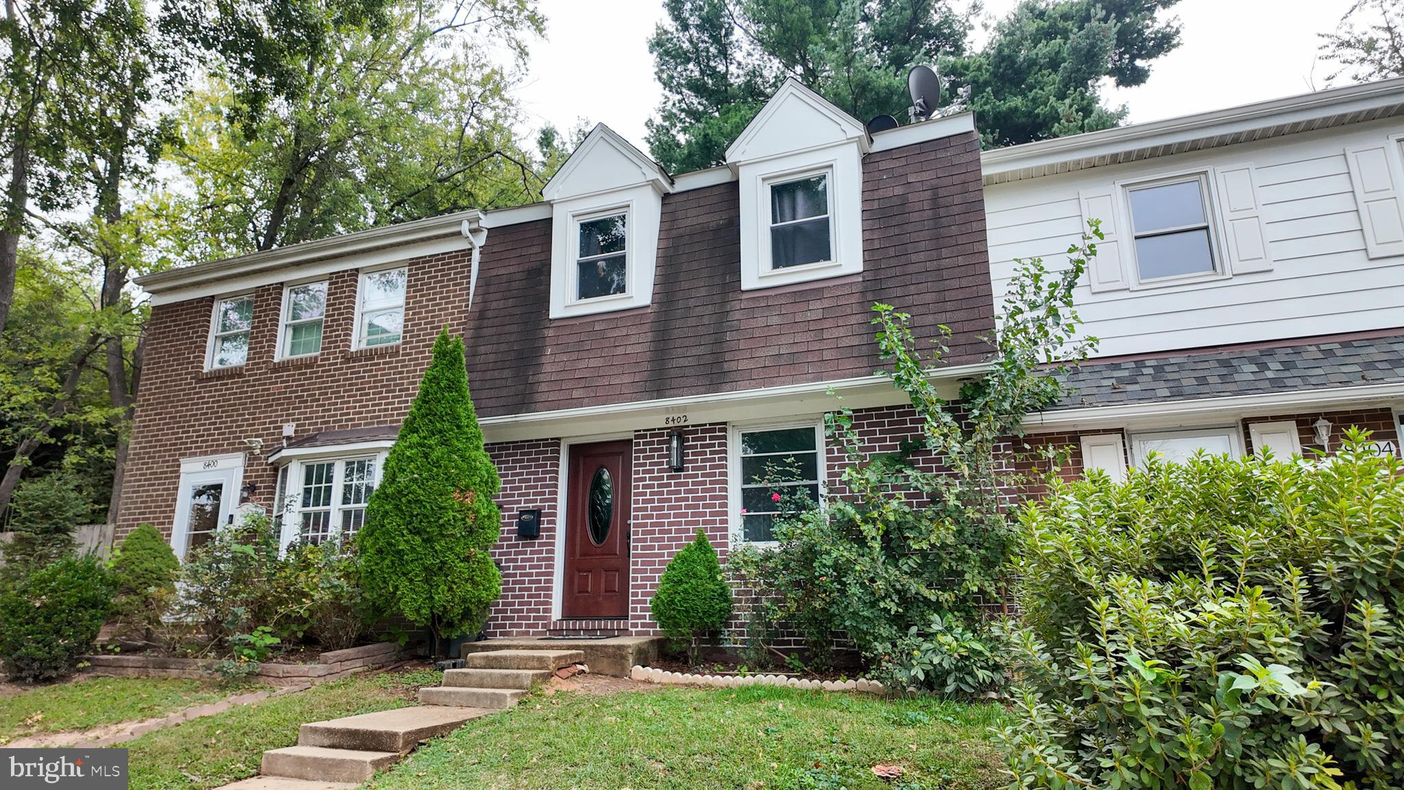 8402 Towne Crest Court Gaithersburg, MD 20877 - Photo 3 of 22 Charming townhouse with lush greenery.