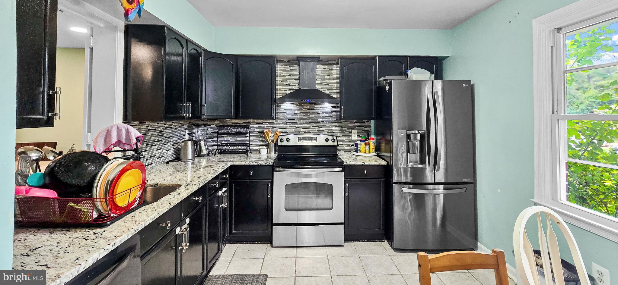 8402 Towne Crest Court Gaithersburg, MD 20877 - Photo 5 of 22 Modern kitchen with sleek black cabinetry.