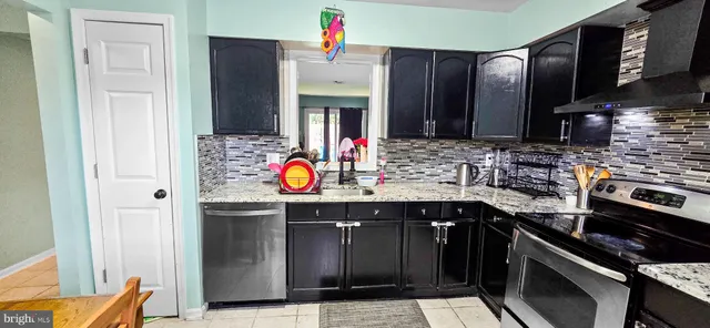 a kitchen with stainless steel appliances a sink stove and cabinets