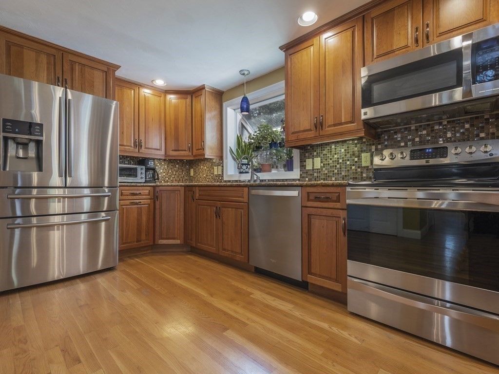 2 Deer Run Road Easton, MA 02356 - Photo 19 of 42 a kitchen with stainless steel appliances granite countertop a stove a sink dishwasher a refrigerator and cabinets with wooden floor