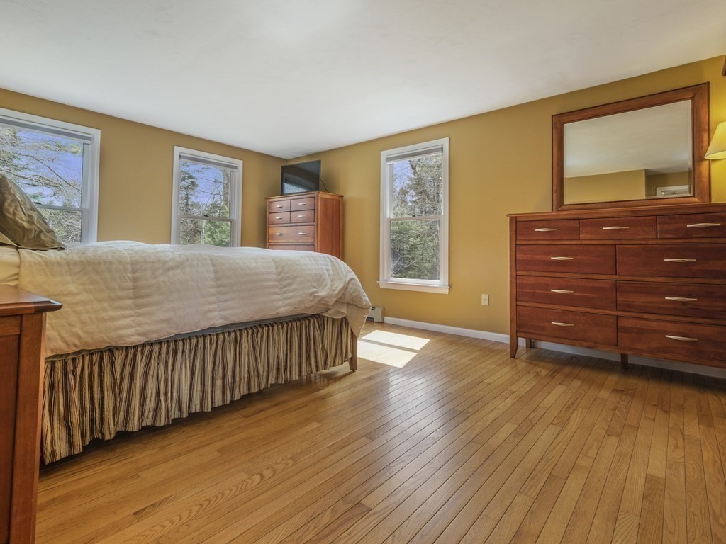2 Deer Run Road Easton, MA 02356 - Photo 29 of 42 a bedroom with a bed and wooden floor